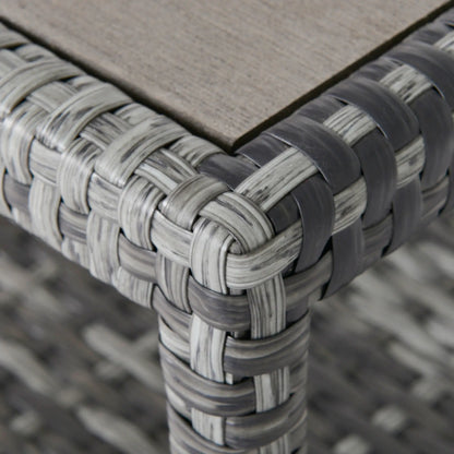 Close-up of a woven chair corner with a wooden seat.