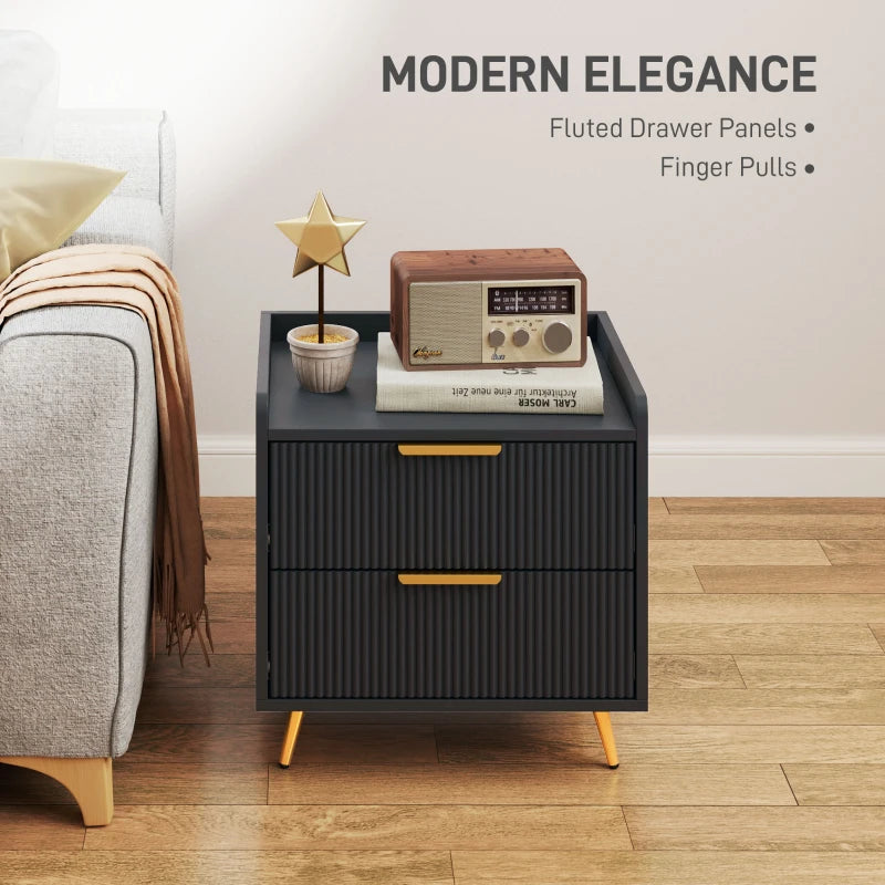 Black nightstand with fluted drawer panels and finger pulls in a bedroom setting.