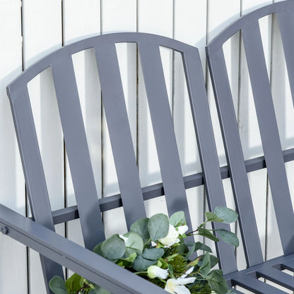 Gray metal bench with a white flower arrangement against a light wooden panel background