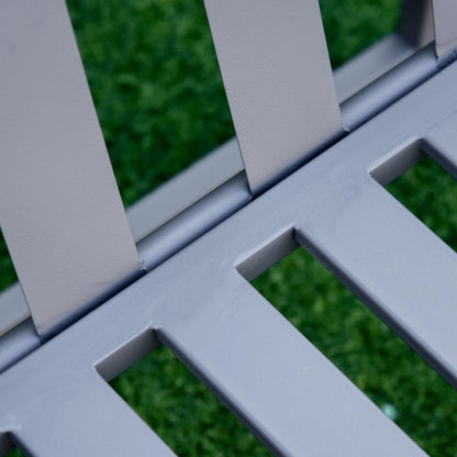 Close-up of a metal grid with green grass in the background