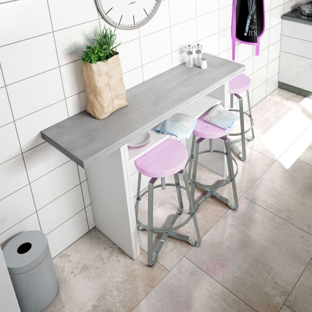 Small kitchen island with stools against a tiled wall.
