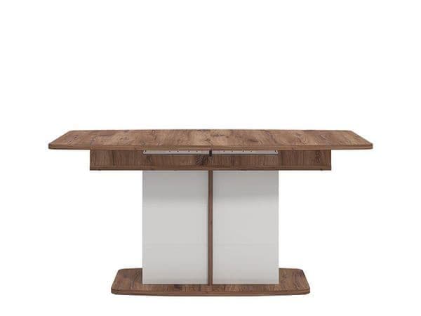 Wooden dining table with a white base on a white background