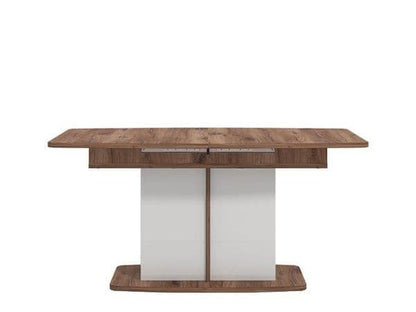 Wooden dining table with a white base on a white background