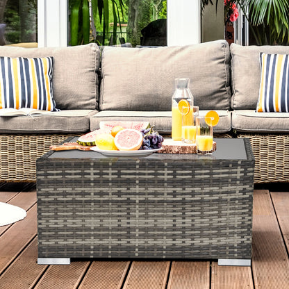 Outdoor patio set with a coffee table, cushions, and fruit on a wooden deck.