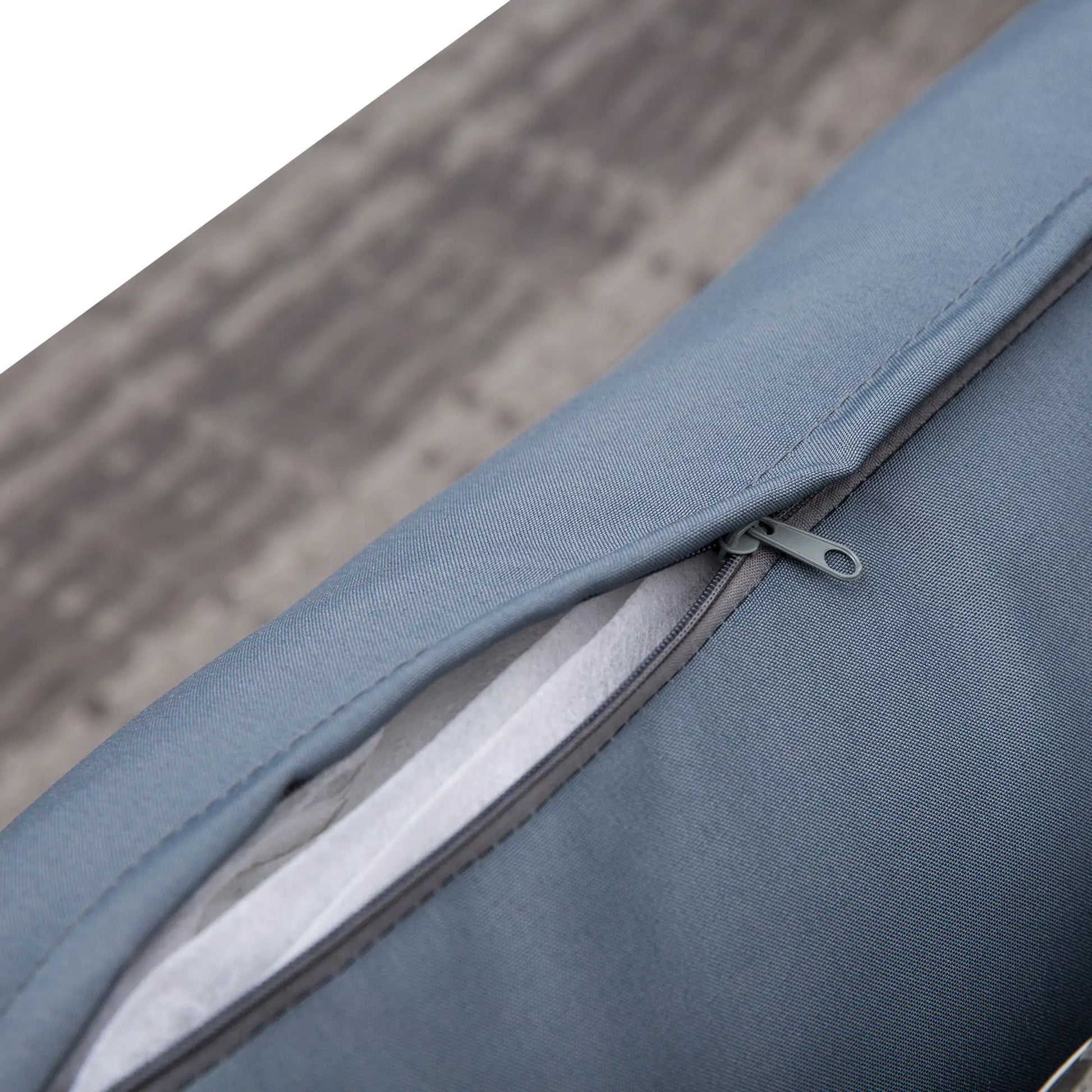 Close-up of a blue fabric bag with a zipper on a blurred background