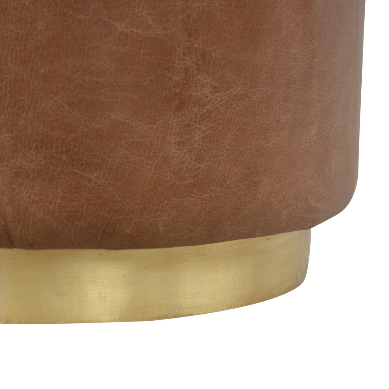 Close-up of a brown leather stool with a gold metal base on a white background