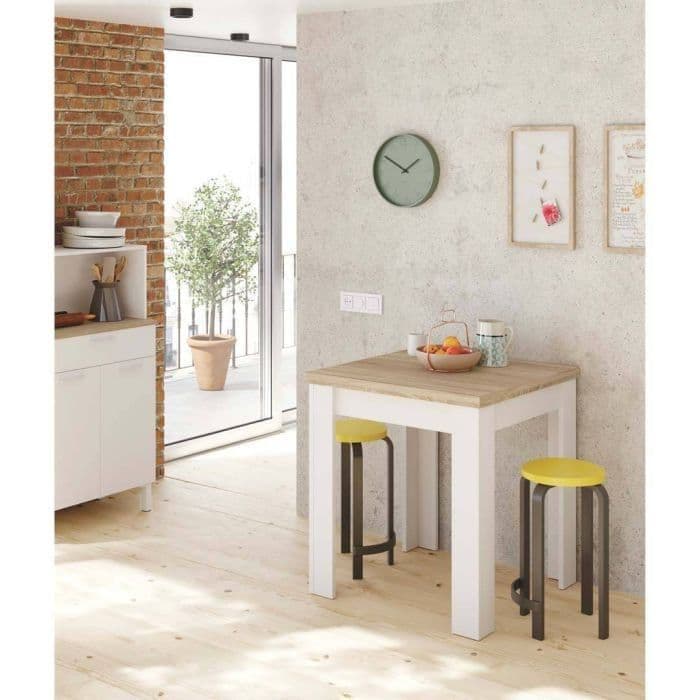 Small dining area with a wooden table and yellow stools in a modern kitchen.