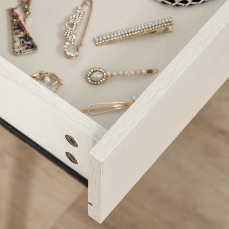 Open jewelry box with various decorative pins and brooches on a neutral background