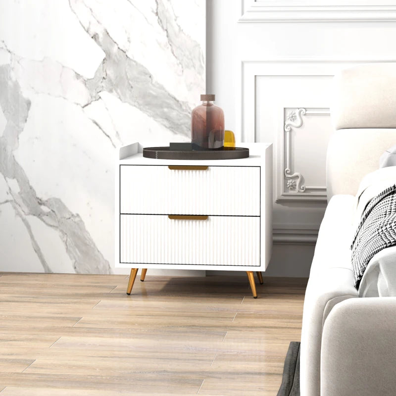 Modern white nightstand with gold legs in a bedroom setting