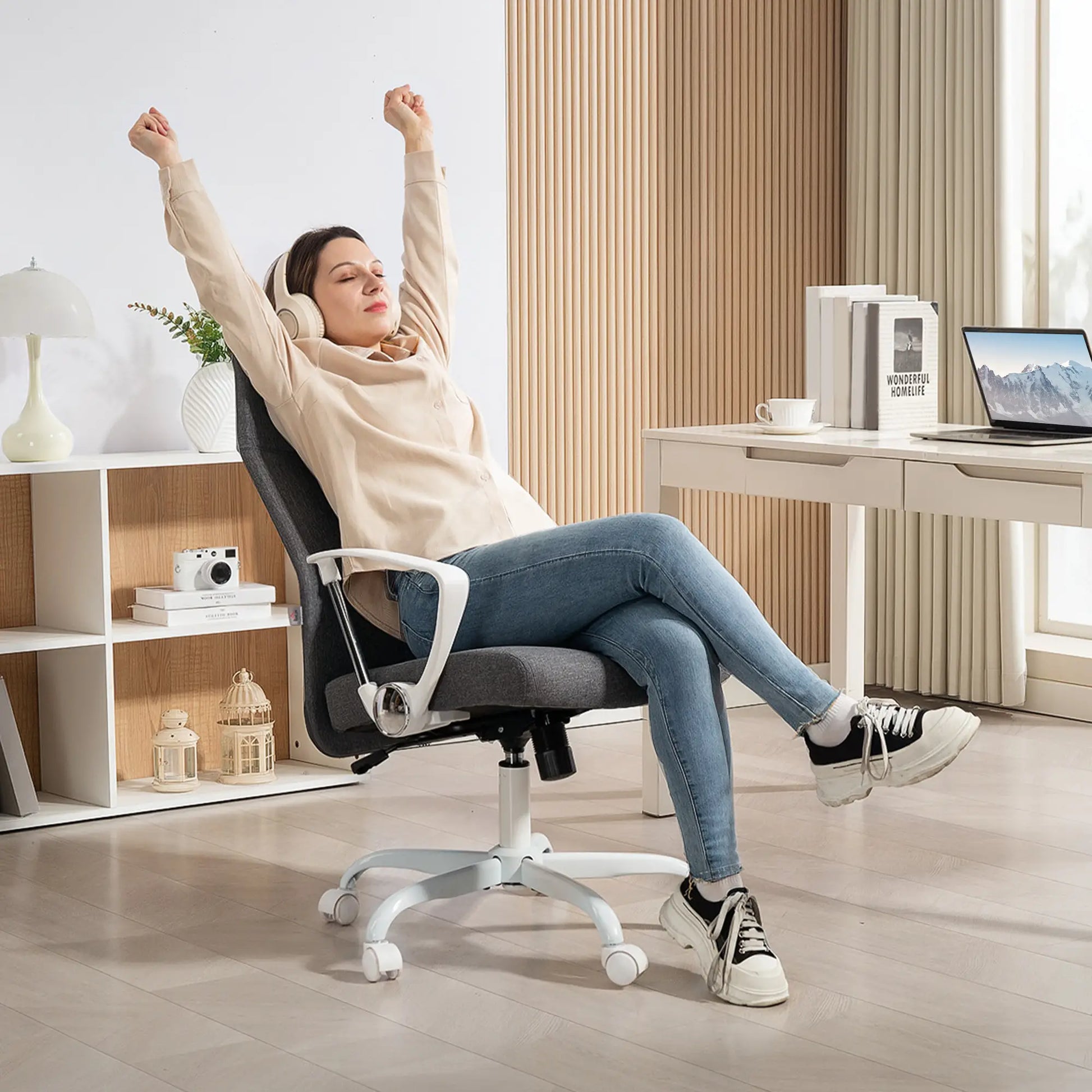 Woman relaxing on a modern office chair in a home office setting.