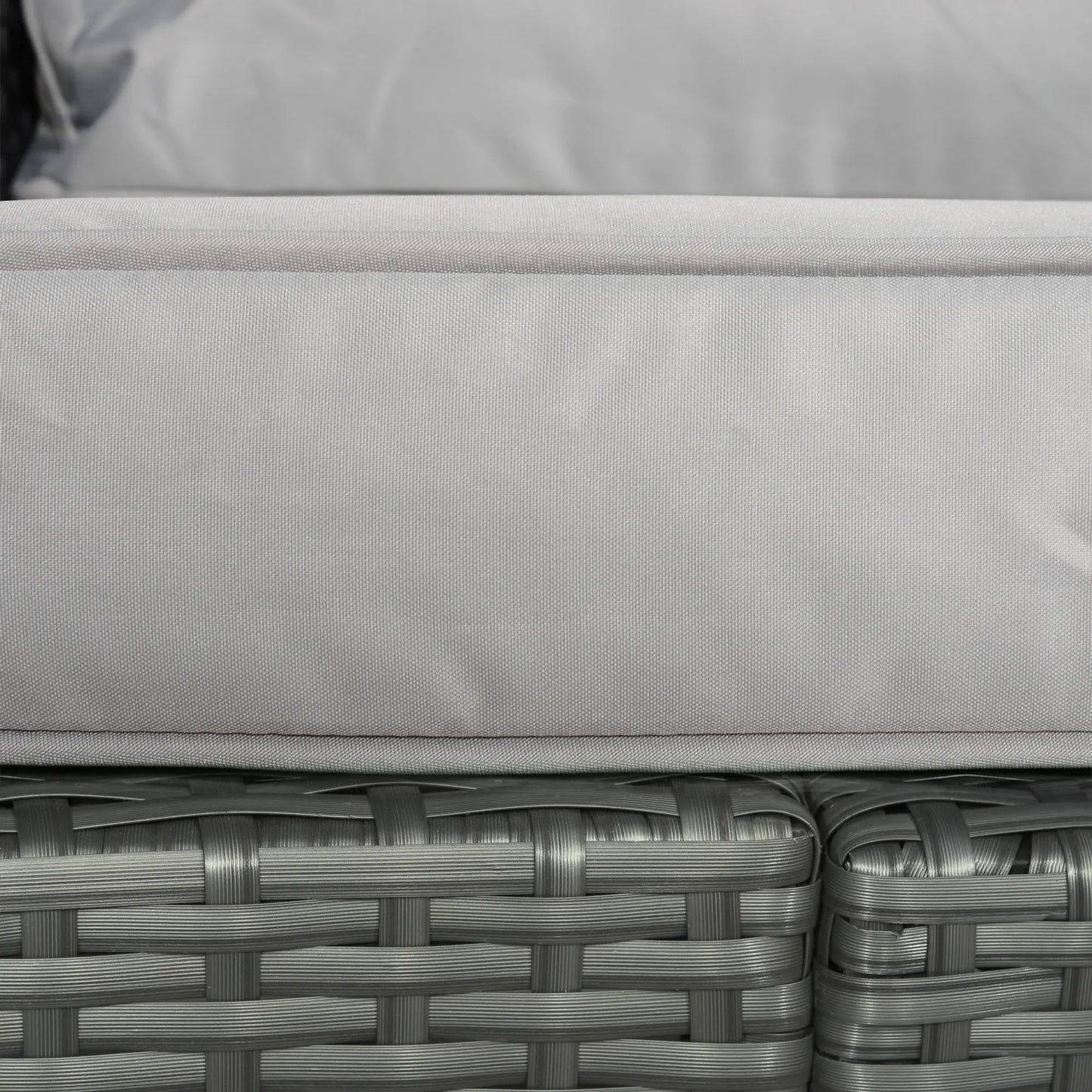 Close-up of a gray cushion on wicker furniture