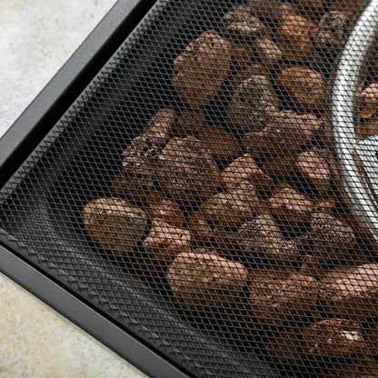 Close-up of roasted coffee beans in a black mesh container.