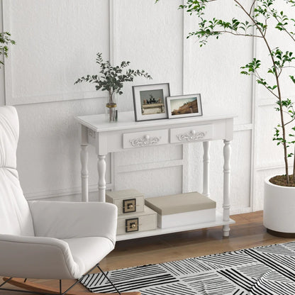 White console table with decorative items in a room with a white armchair and plants.